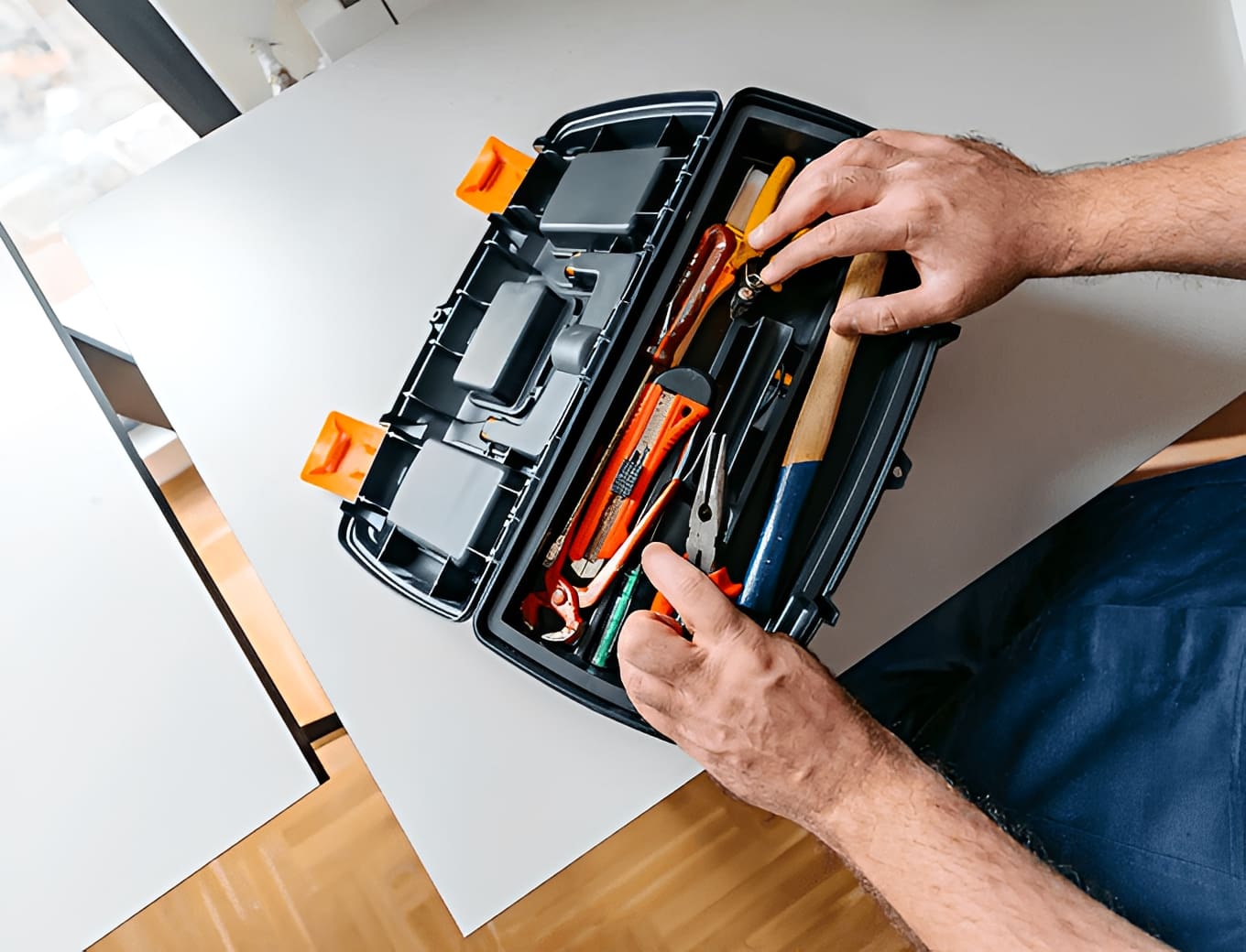 Person organizing tools in a toolbox.