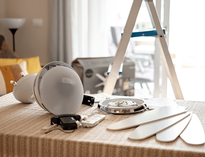 Ceiling fan parts on a table.